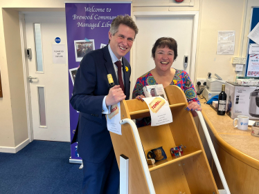 Sir Gavin Williamson is joined by a volunteer at the Marie Curie coffee morning
