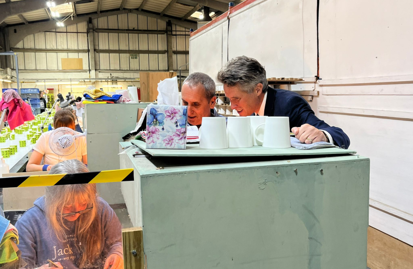 Sir Gavin Williamson watches the process of a mug being made at Dunoon