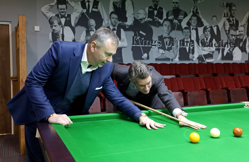 Sir Gavin and Jason Ferguson lining up a snooker shot