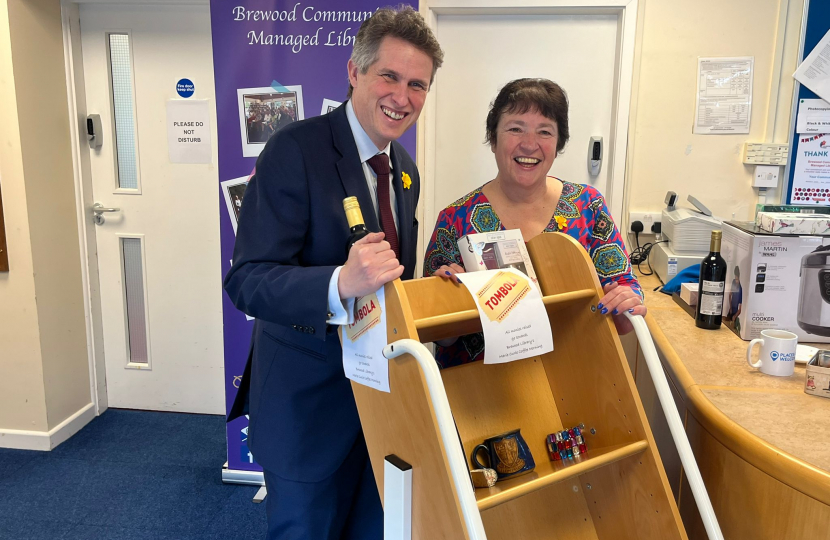 Sir Gavin Williamson is joined by a volunteer at the Marie Curie coffee morning