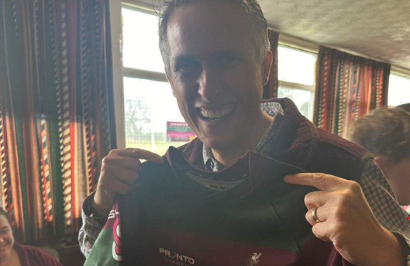 Sir Gavin Williamson holding the new club kit