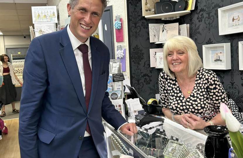 Sir Gavin Williamson smiles with a shop owner on Stone High Street