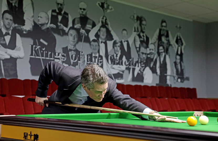 Sir Gavin lining up a snooker shot