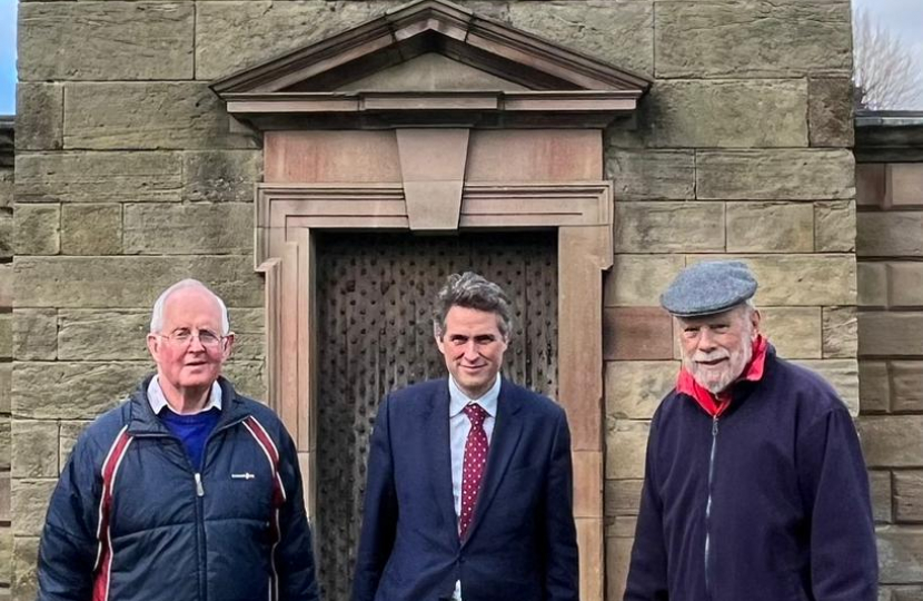 Sir Gavin is joined by Councillor Philip Leason and a volunteer, they stand infront of the Jervis family mausoleum