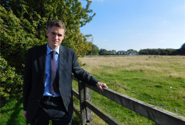 Sir Gavin Williamson MP by an area of greenbelt land