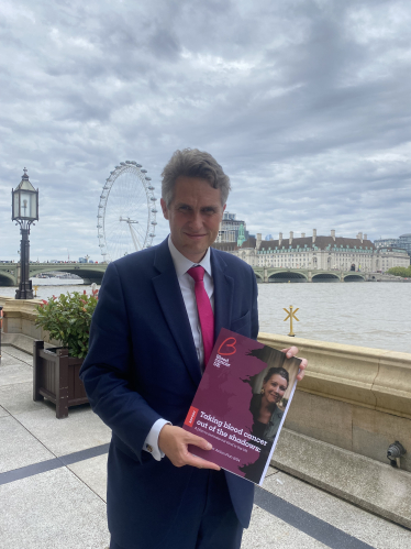 Sir Gavin poses with the new report by Blood Cancer UK on the terrace of the Palace of Westminster