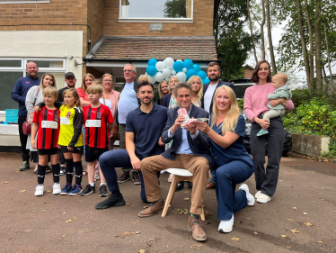 Sir Gavin Williamson is joined by Naomi and Johnathan Price among a group of supporters as they sit outside the new Codsall Health Care Centre