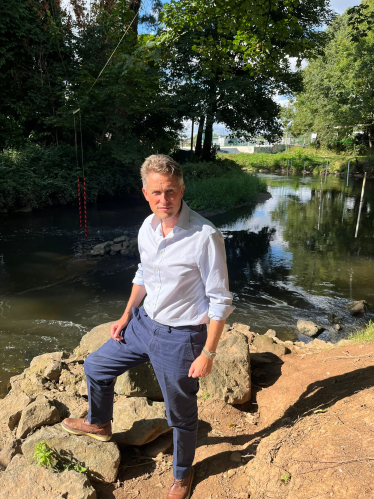 Sir Gavin Williamson stands infront of the River Trent