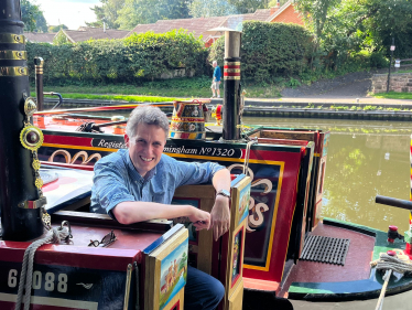 Sir Gavin Williamson smiling on board a Staffordshire narrowboat